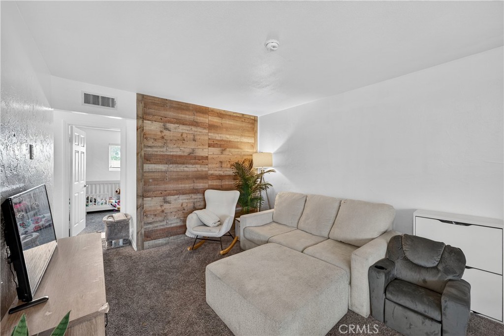 1430 West Lambert Road, Unit 384 La Habra, CA 90631 - Photo 8 of 41 a living room with furniture and a flat screen tv