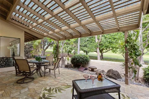 a view of a patio with table and chairs and potted plants