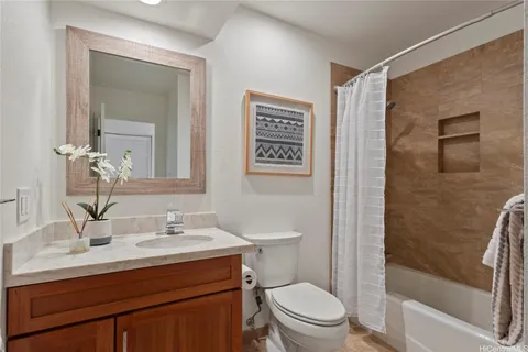 a bathroom with a sink toilet a mirror and shower