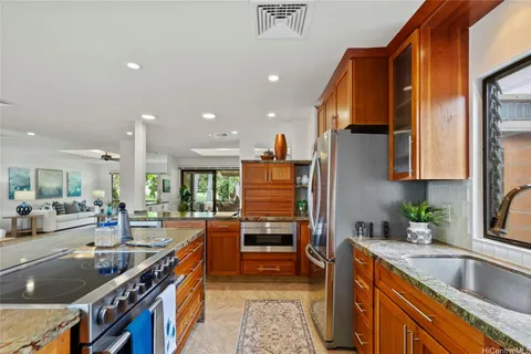 a kitchen with stainless steel appliances a sink stove and cabinets