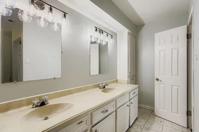 a bathroom with a double vanity sink mirror and double
