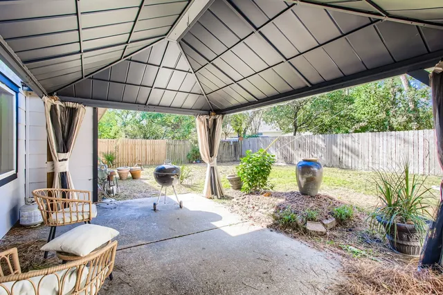 a backyard of a house with yard and outdoor seating