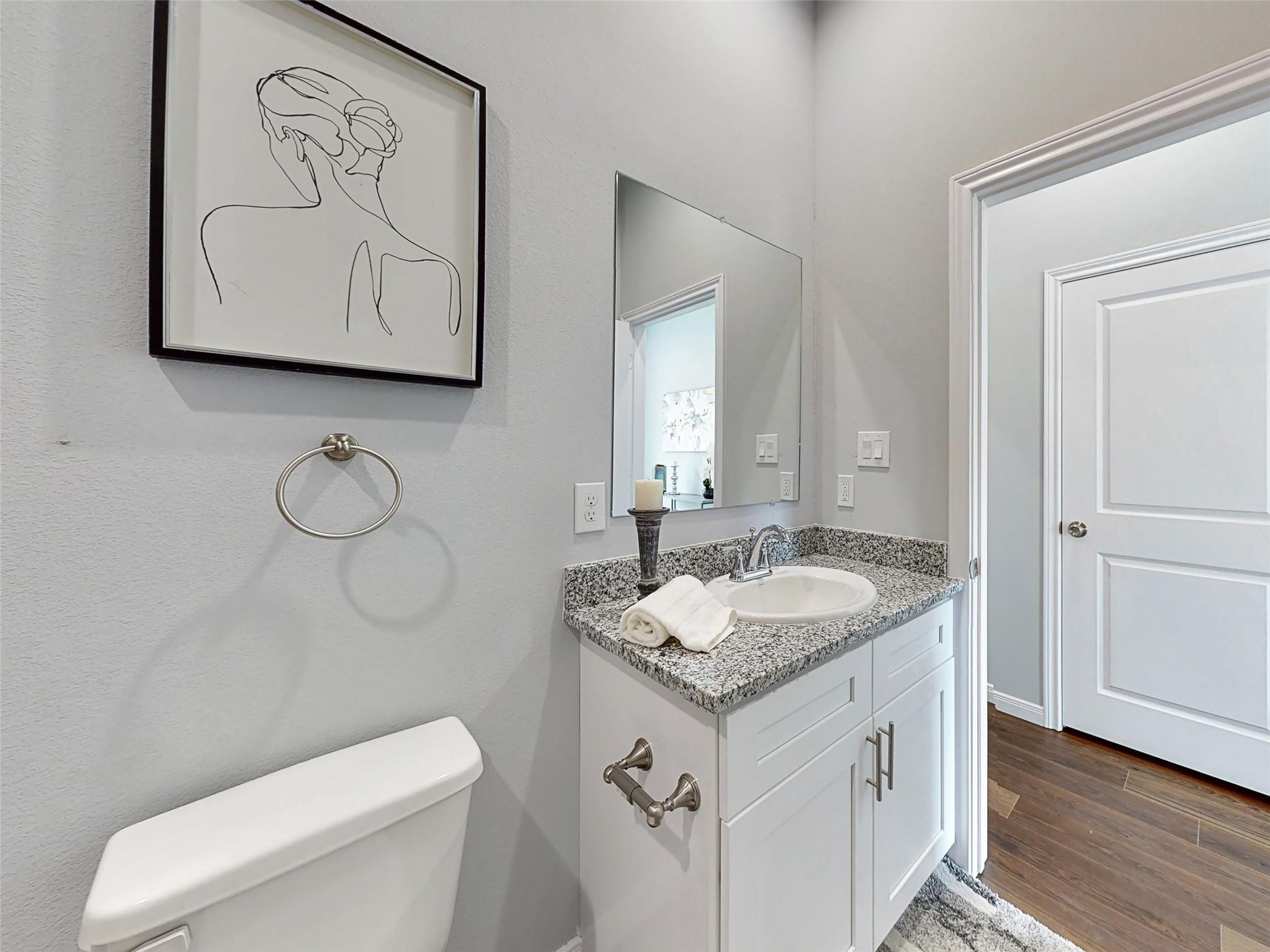 18813 Luminescent Lane Spring, TX 77379 - Photo 15 of 19 a bathroom with a granite countertop sink and a toilet