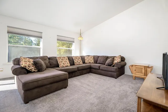 a view of a livingroom with a window and a ceiling fan