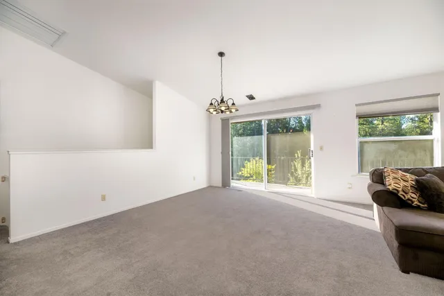a spacious bathroom with a granite countertop sink a mirror and a bathtub