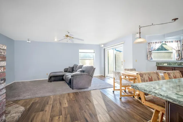 a bathroom with a granite countertop sink a mirror and shower