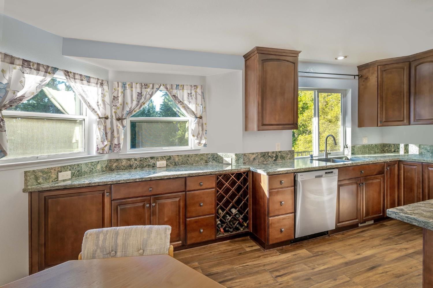 12401 Old Mine Road Grass Valley, CA 95945 - Photo 35 of 87 a kitchen with stainless steel appliances granite countertop a stove a sink and a wooden cabinets