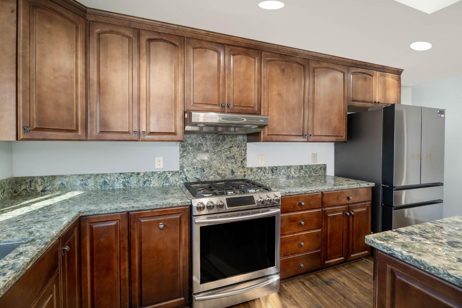 12401 Old Mine Road Grass Valley, CA 95945 - Photo 36 of 87 a kitchen with granite countertop wooden cabinets and stainless steel appliances