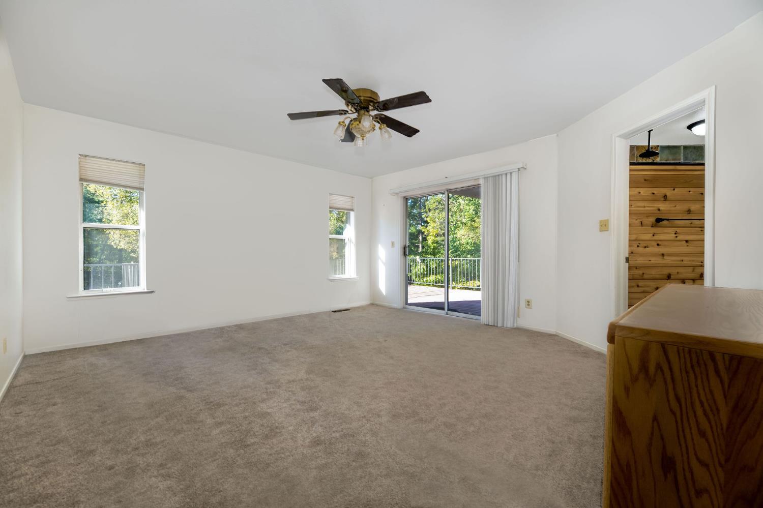 12401 Old Mine Road Grass Valley, CA 95945 - Photo 42 of 87 a view of a livingroom with a window and a ceiling fan