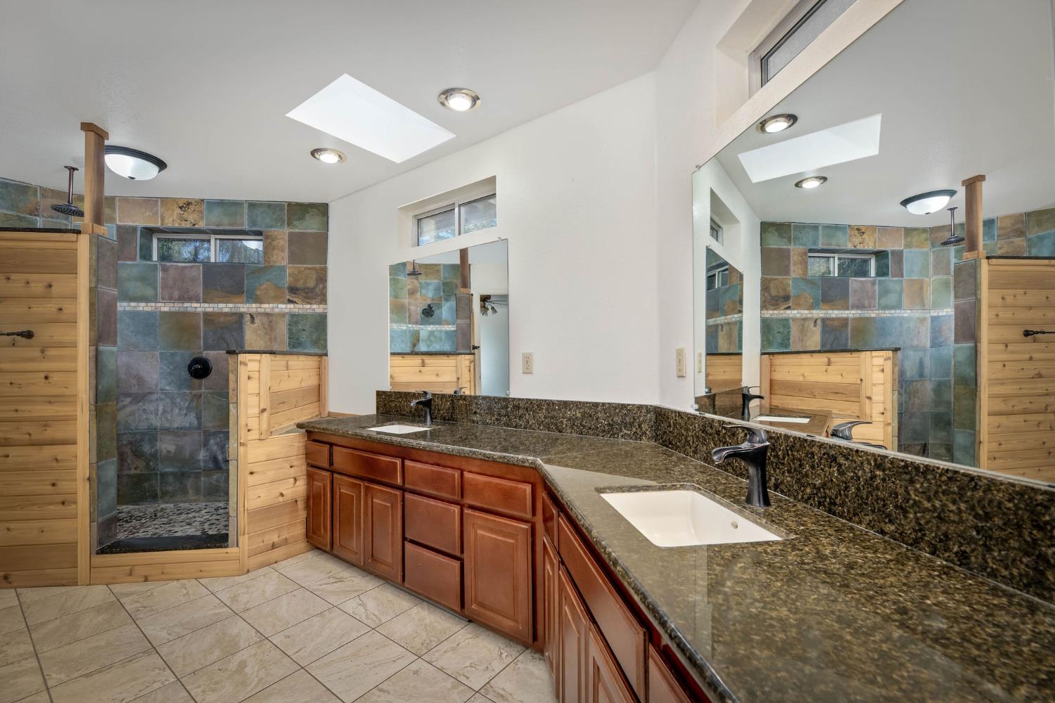 12401 Old Mine Road Grass Valley, CA 95945 - Photo 47 of 87 a bathroom with a granite countertop sink a mirror and shower