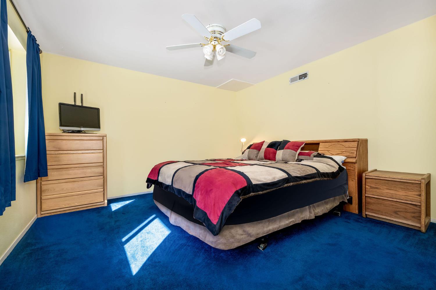 12401 Old Mine Road Grass Valley, CA 95945 - Photo 64 of 87 a bedroom with a bed and a ceiling fan