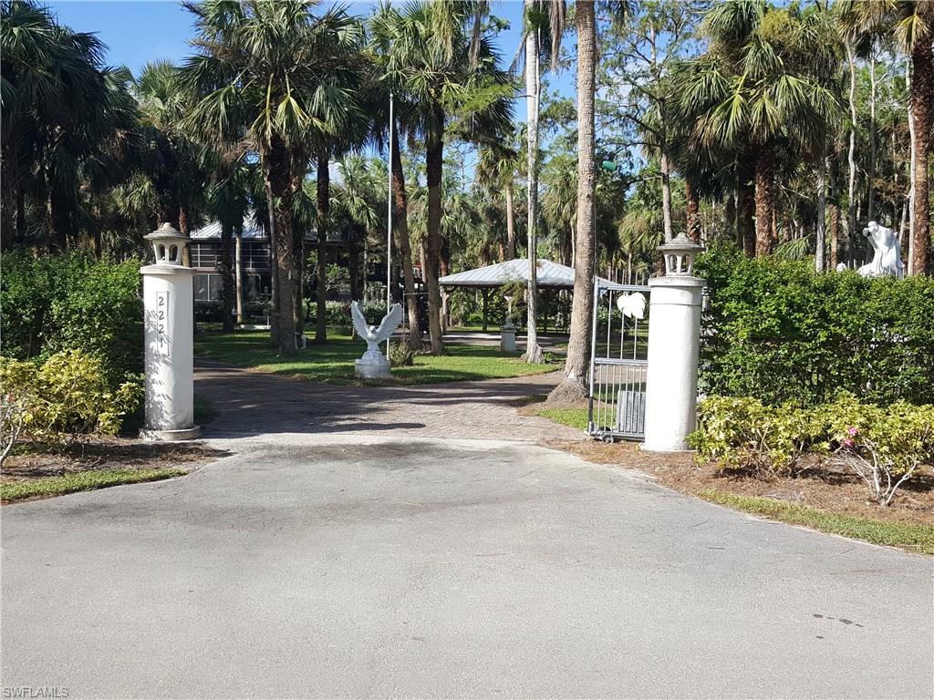 2221 Krape Road Naples, FL 34120 - Photo 1 of 24 a view of a house with a yard and coconut trees