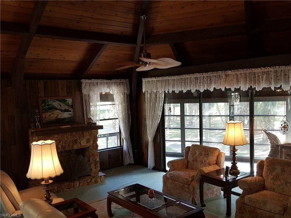 2221 Krape Road Naples, FL 34120 - Photo 5 of 24 a living room with furniture and a fireplace