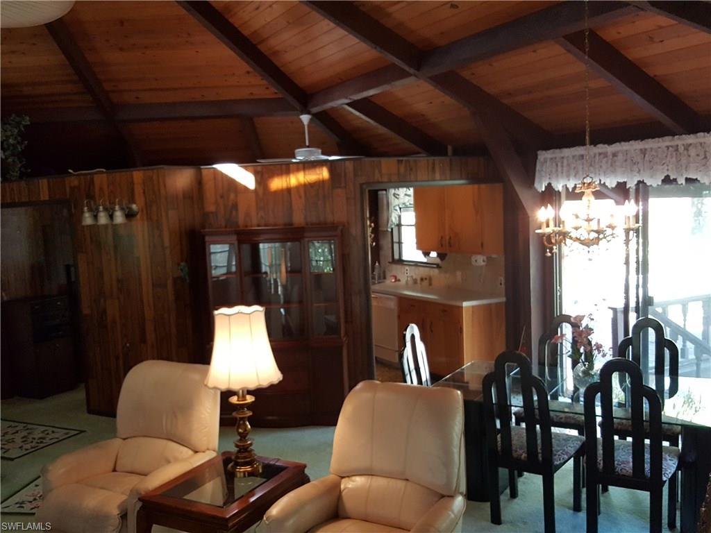2221 Krape Road Naples, FL 34120 - Photo 6 of 24 a living room with furniture and a lamp