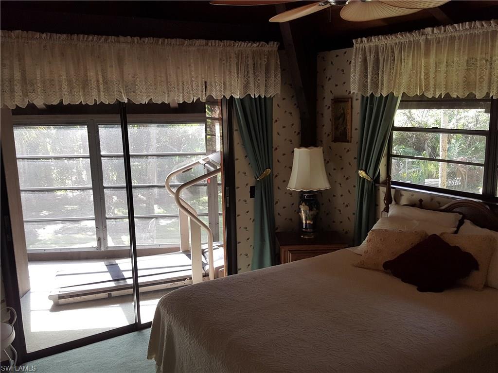 2221 Krape Road Naples, FL 34120 - Photo 7 of 24 a bed room with a bed and a window