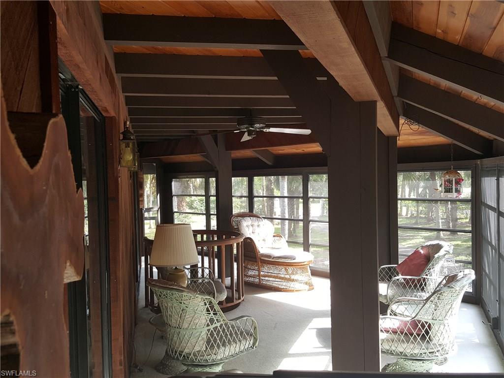 2221 Krape Road Naples, FL 34120 - Photo 9 of 24 a dining room with furniture and wooden floor