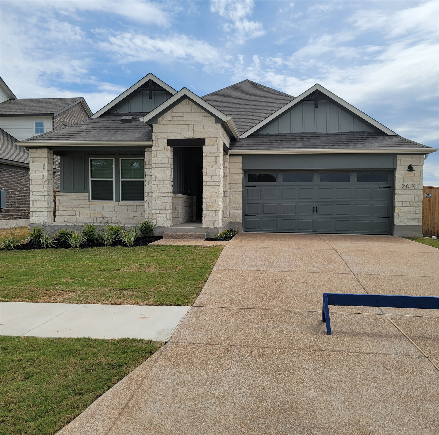 200 Callahan Loop Buda, TX 78610 - Photo 1 of 13 Modern exterior featuring light-colored stone and vertical siding accents