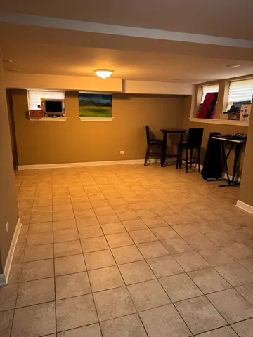 a view of a livingroom with kitchen and a window