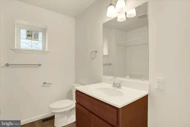 a bathroom with a sink toilet and a mirror