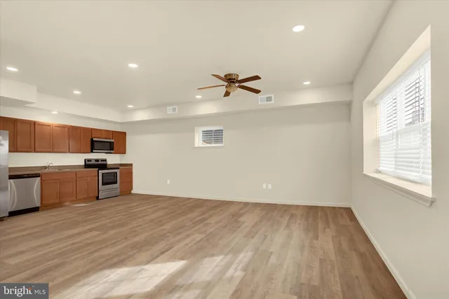 a view of kitchen with microwave and stove top oven