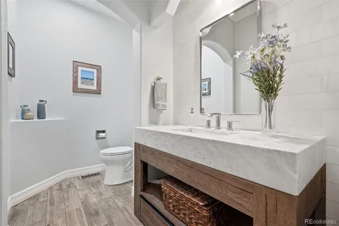 a kitchen with stainless steel appliances granite countertop a stove a sink and white cabinets