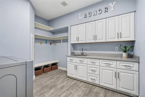 a view of washer and dryer with kitchen in the background