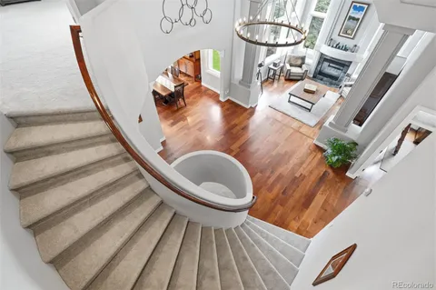a spacious bedroom with a bed and a chandelier
