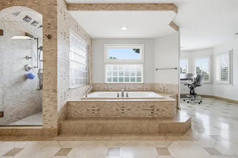 a bedroom with a bed and a lounge chair