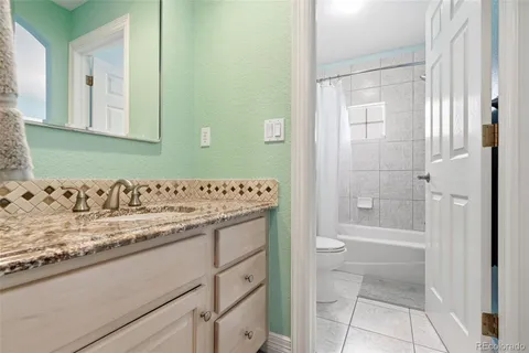 a spacious bedroom with a bed and a window