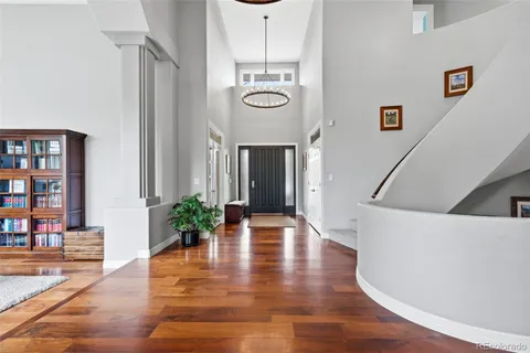 a view of a livingroom with wooden floor and a potted plant