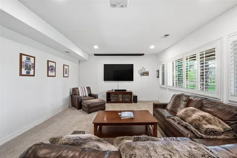 a kitchen with stainless steel appliances kitchen island granite countertop a table chairs microwave and sink