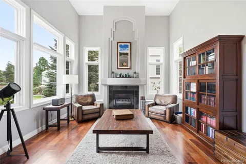 a living room with furniture large window and a fireplace