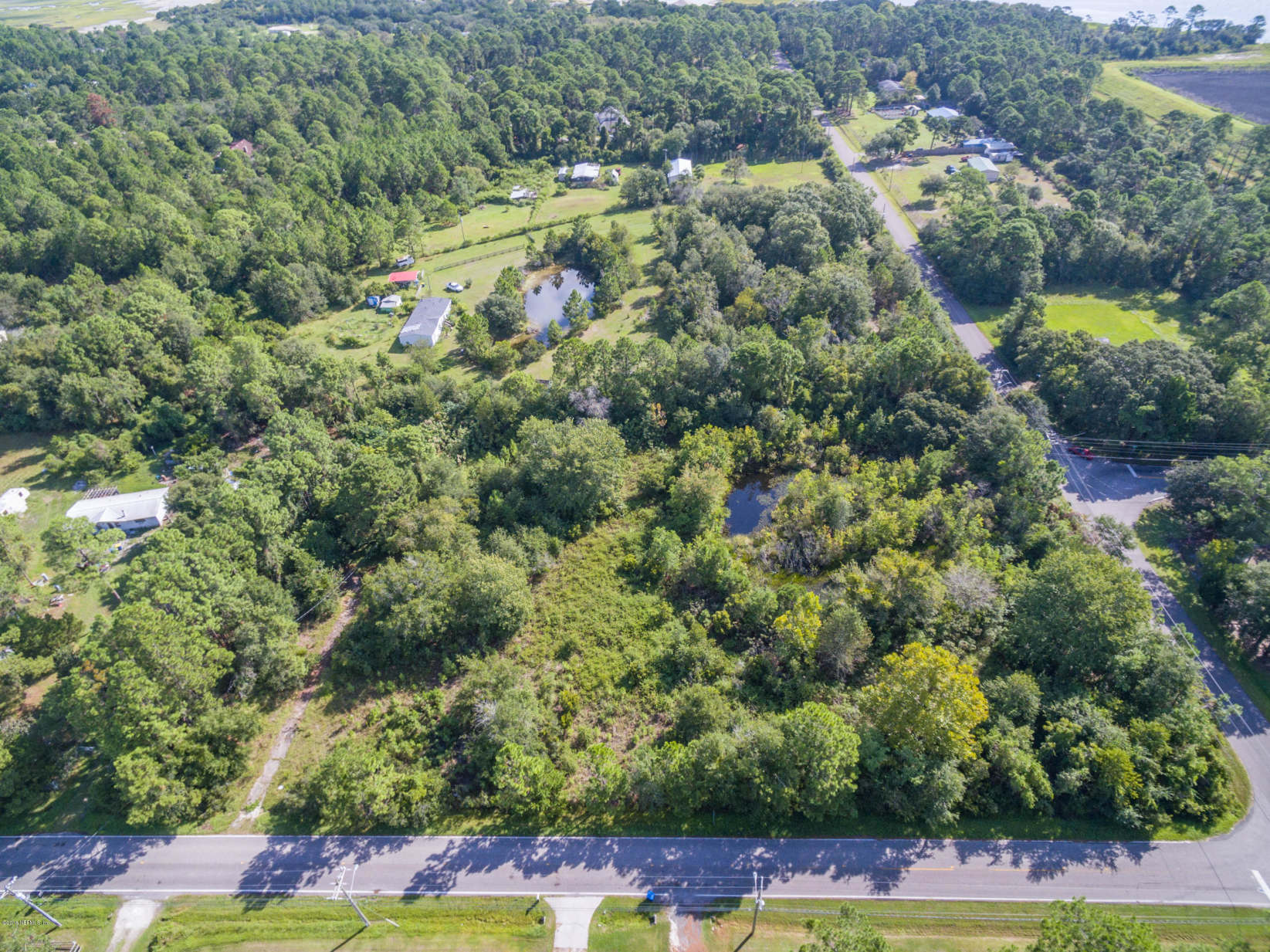 10161 Sawpit Road Jacksonville, FL 32226 - Photo 1 of 4 an aerial view of residential houses with yard and swimming pool