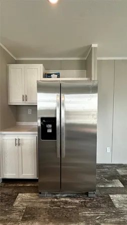 a kitchen with a refrigerator stove and cabinets
