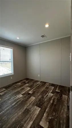 a view of an empty room and wooden floor