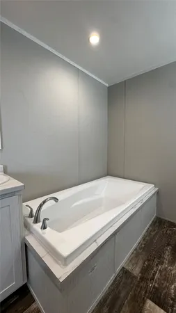 a bathroom with a toilet a sink a window and mirror