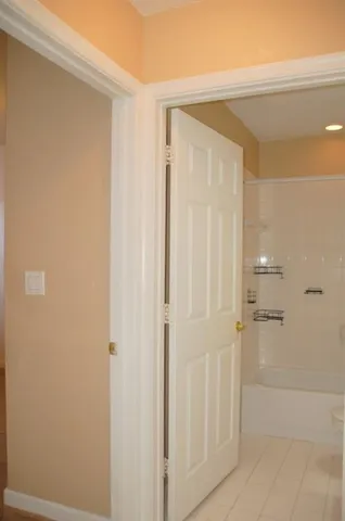 a view of swimming pool with lawn chairs under an umbrella