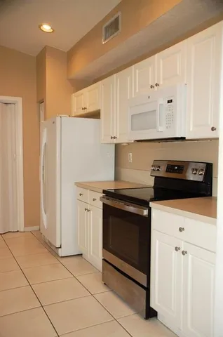 a bedroom with a bed and a potted plant