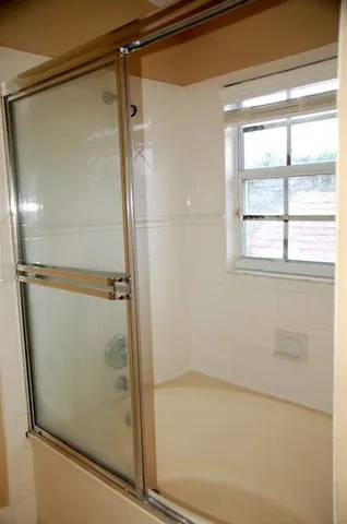 a bedroom with a bed and a potted plant