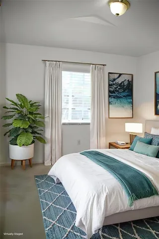 a view of an empty room with a chandelier fan