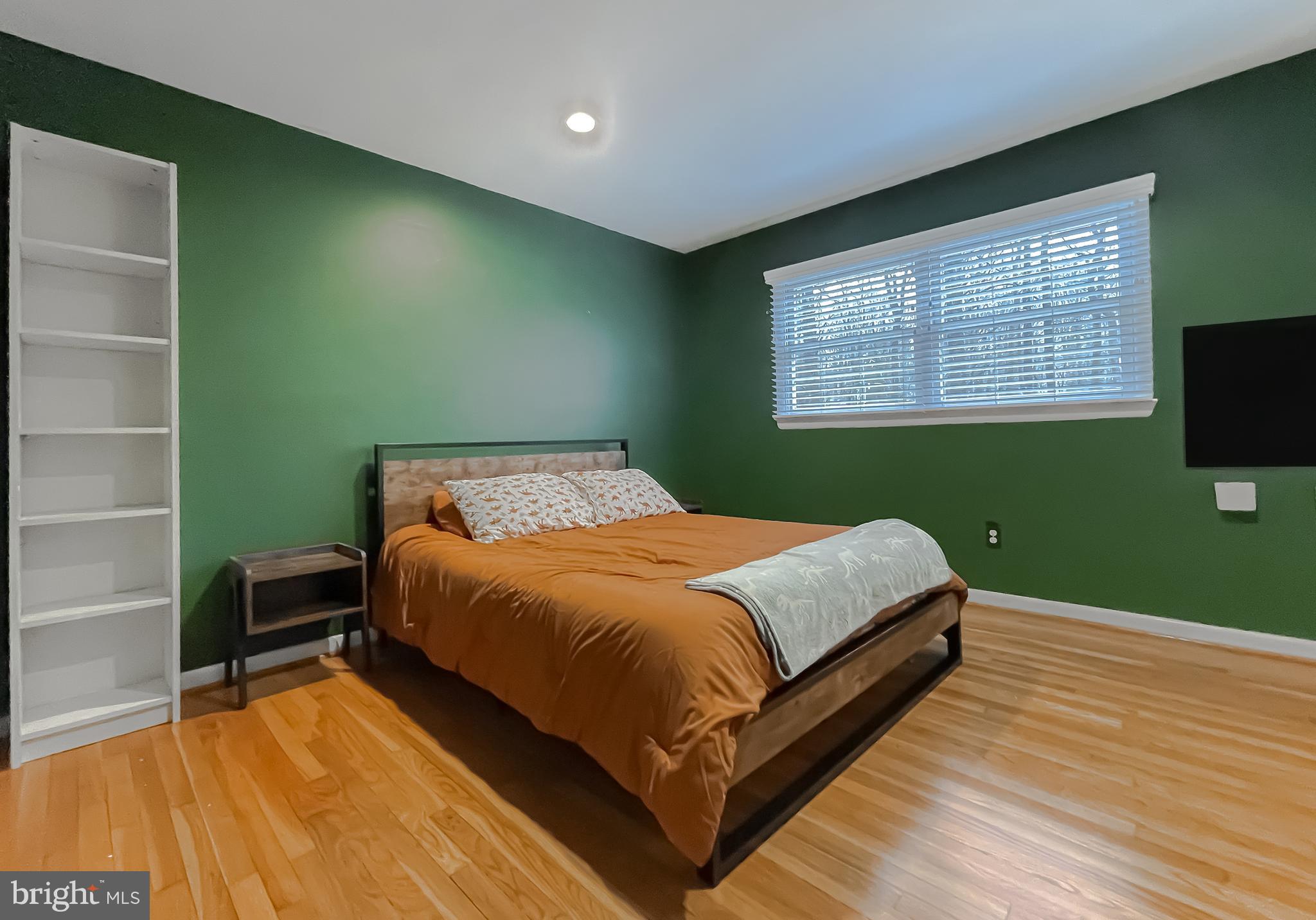 6056 Fir Road St. Leonard, MD 20685 - Photo 21 of 39 a bed sitting in a room next to a window