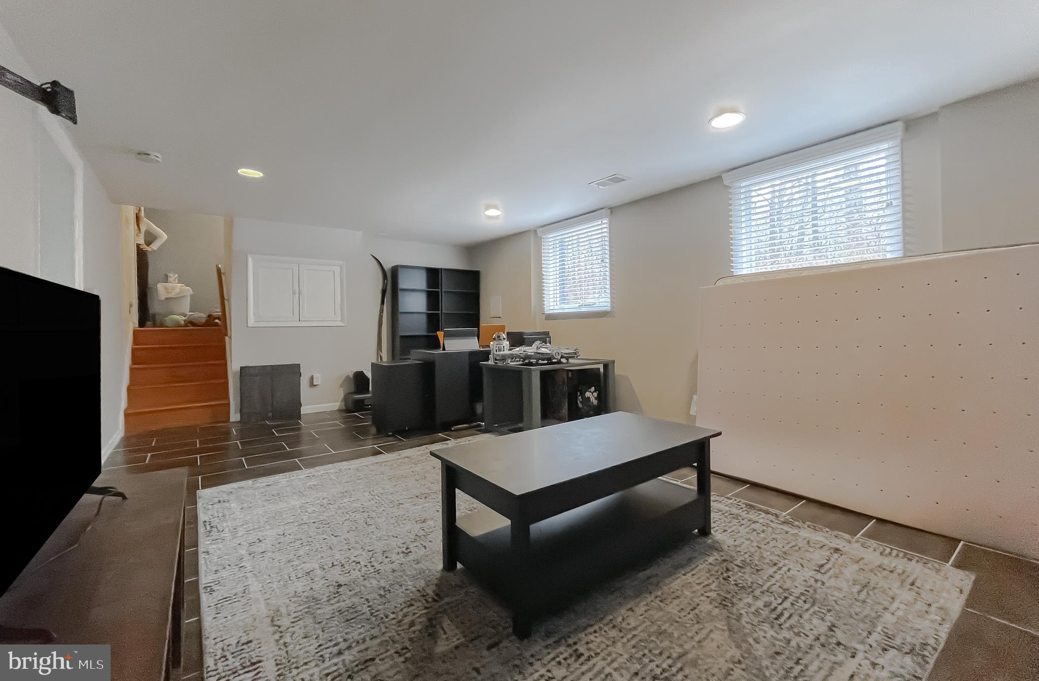 6056 Fir Road St. Leonard, MD 20685 - Photo 29 of 39 a living room with stainless steel appliances kitchen island granite countertop furniture a rug a stove and a window