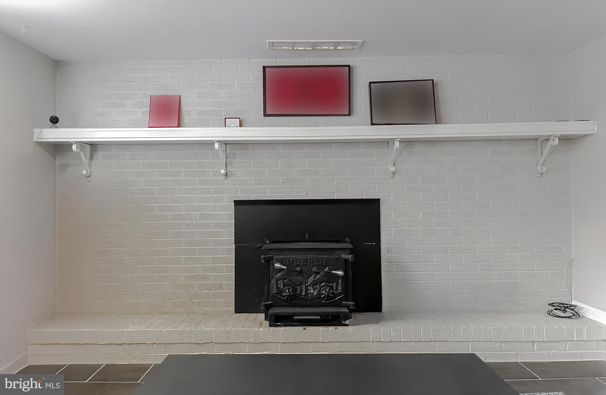 6056 Fir Road St. Leonard, MD 20685 - Photo 32 of 39 a close view of a fireplace in the kitchen
