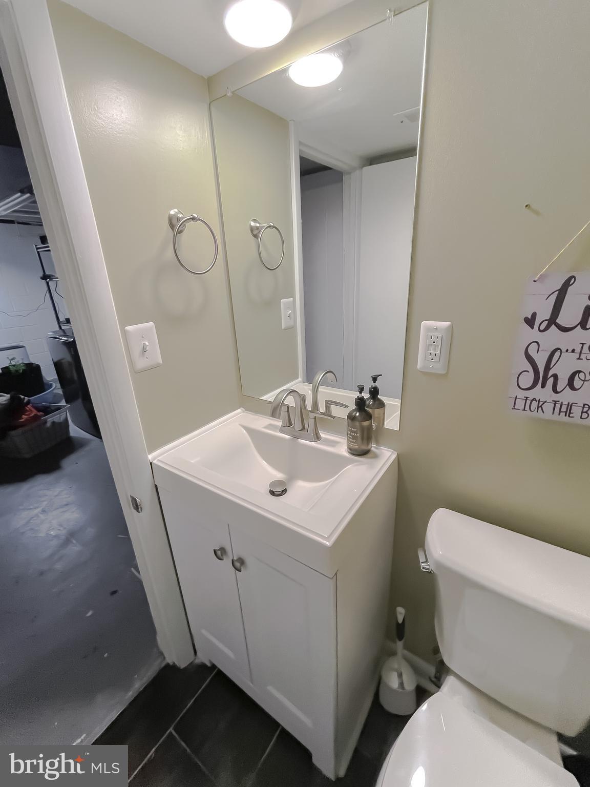 6056 Fir Road St. Leonard, MD 20685 - Photo 33 of 39 a bathroom with a sink toilet and shower