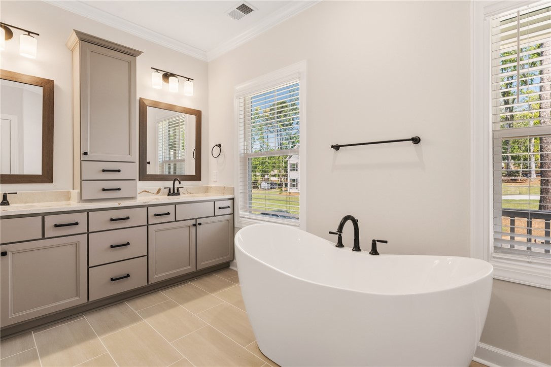 701 Weathered Oak Way Anderson, SC 29621 - Photo 22 of 41 Luxurious bathroom retreat with dual vanities and a freestanding soaking tub.
