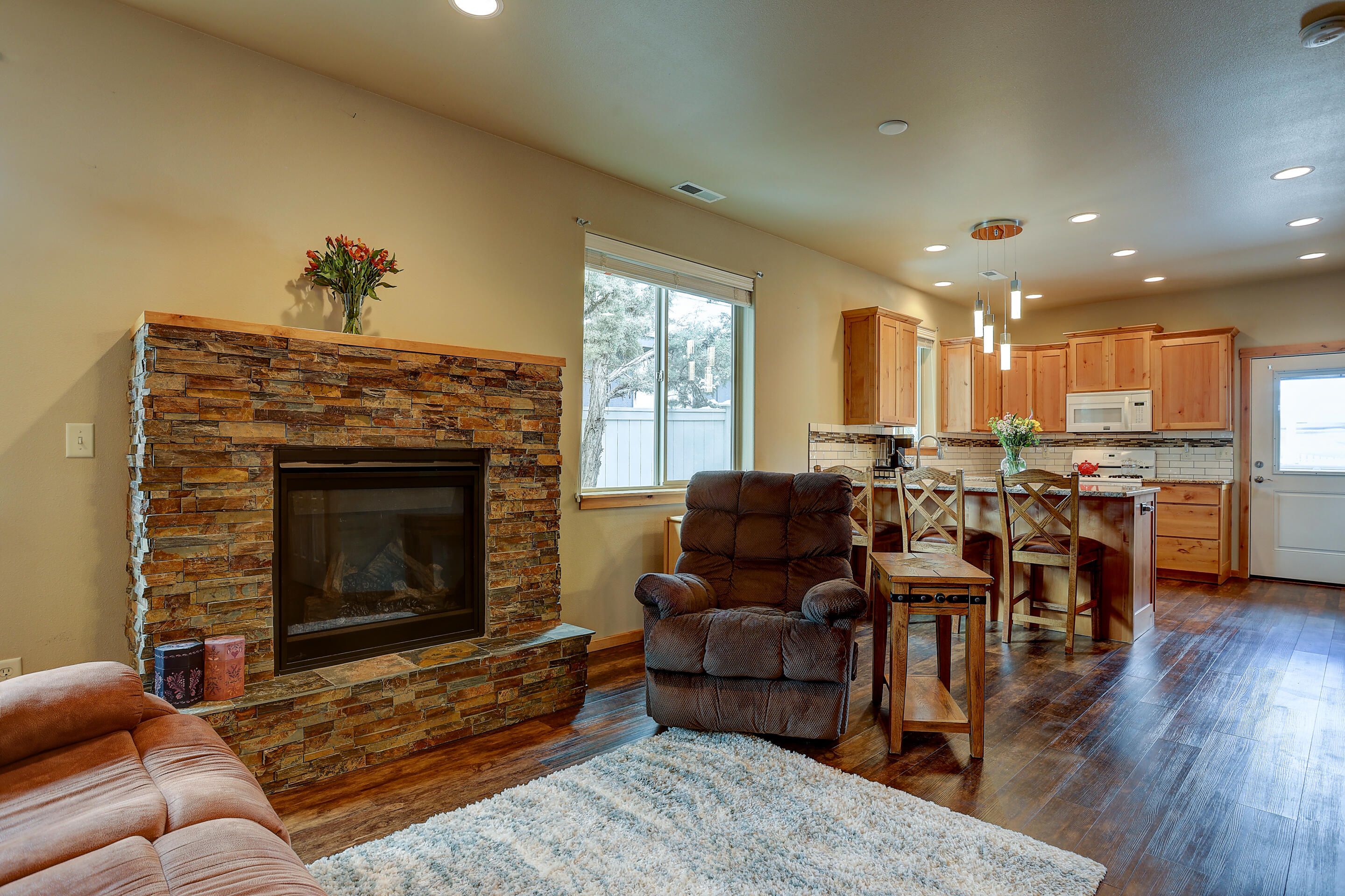 20659 Cooley Road Bend, OR 97701 - Photo 27 of 27 Open great room floor plan with 9 foot ceilings and a gas fireplace with a stone faced hearth and surround. Custom wood cabinets and doors are locally made (except closet doors).