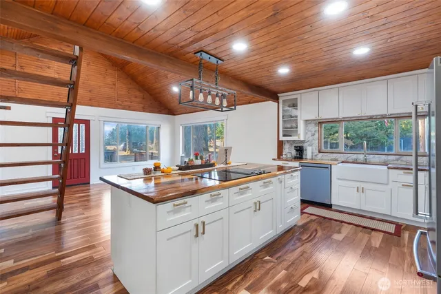 a kitchen with stainless steel appliances a stove a sink and a refrigerator