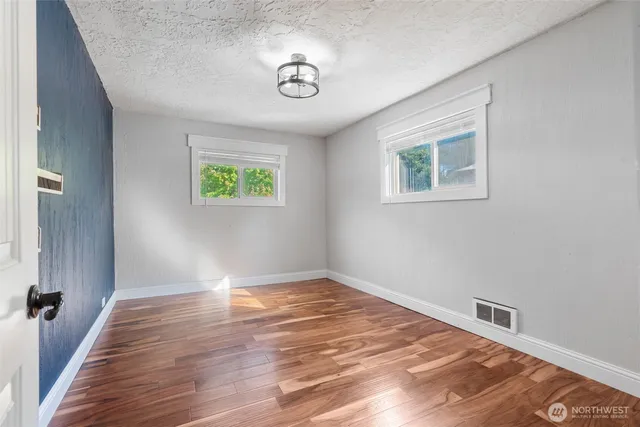 a bed sitting in a bedroom next to a window