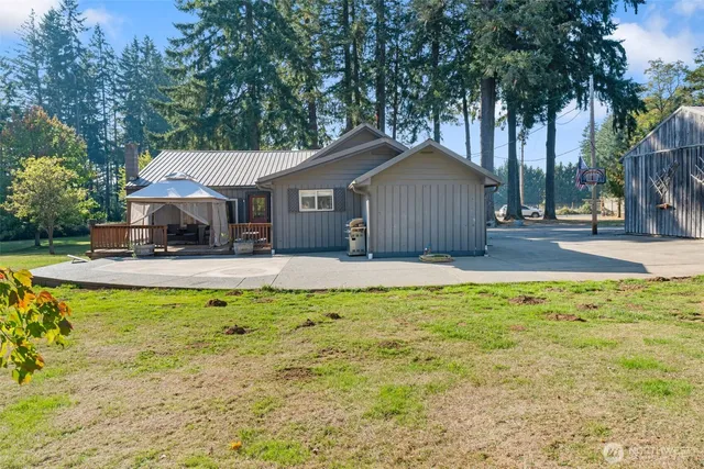 a backyard of a house with yard and tree
