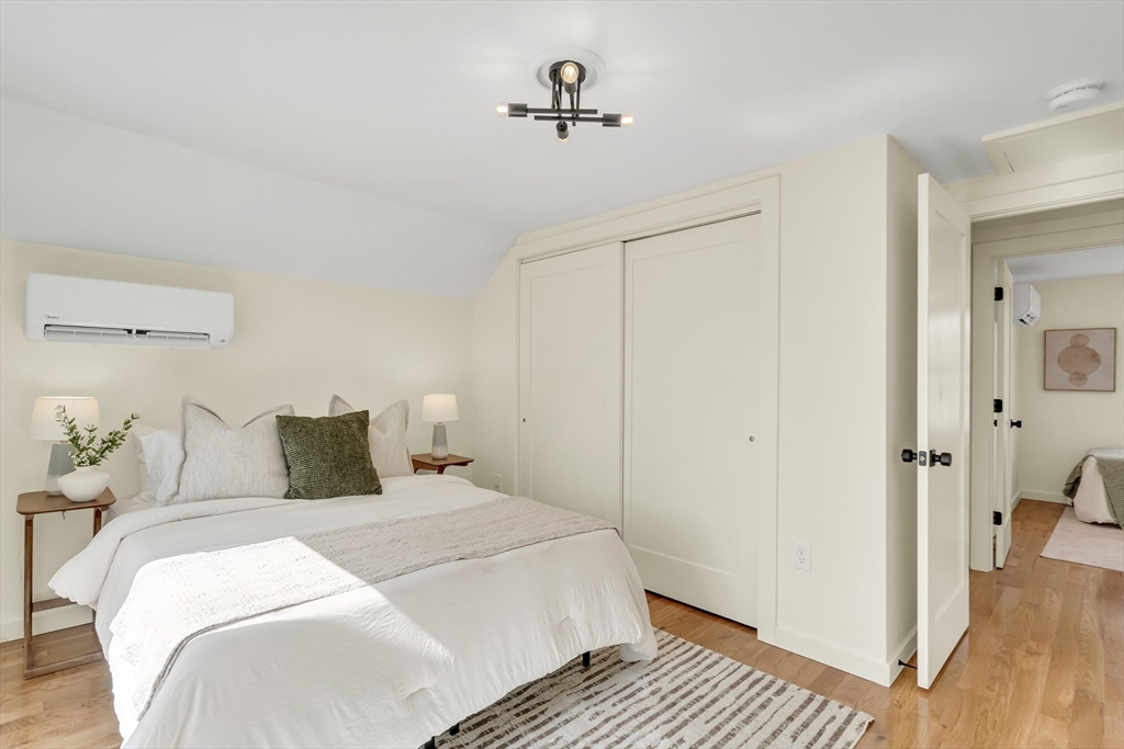 56 Riverview Street Dedham, MA 02026 - Photo 12 of 29 a bedroom with a bed and wooden floor
